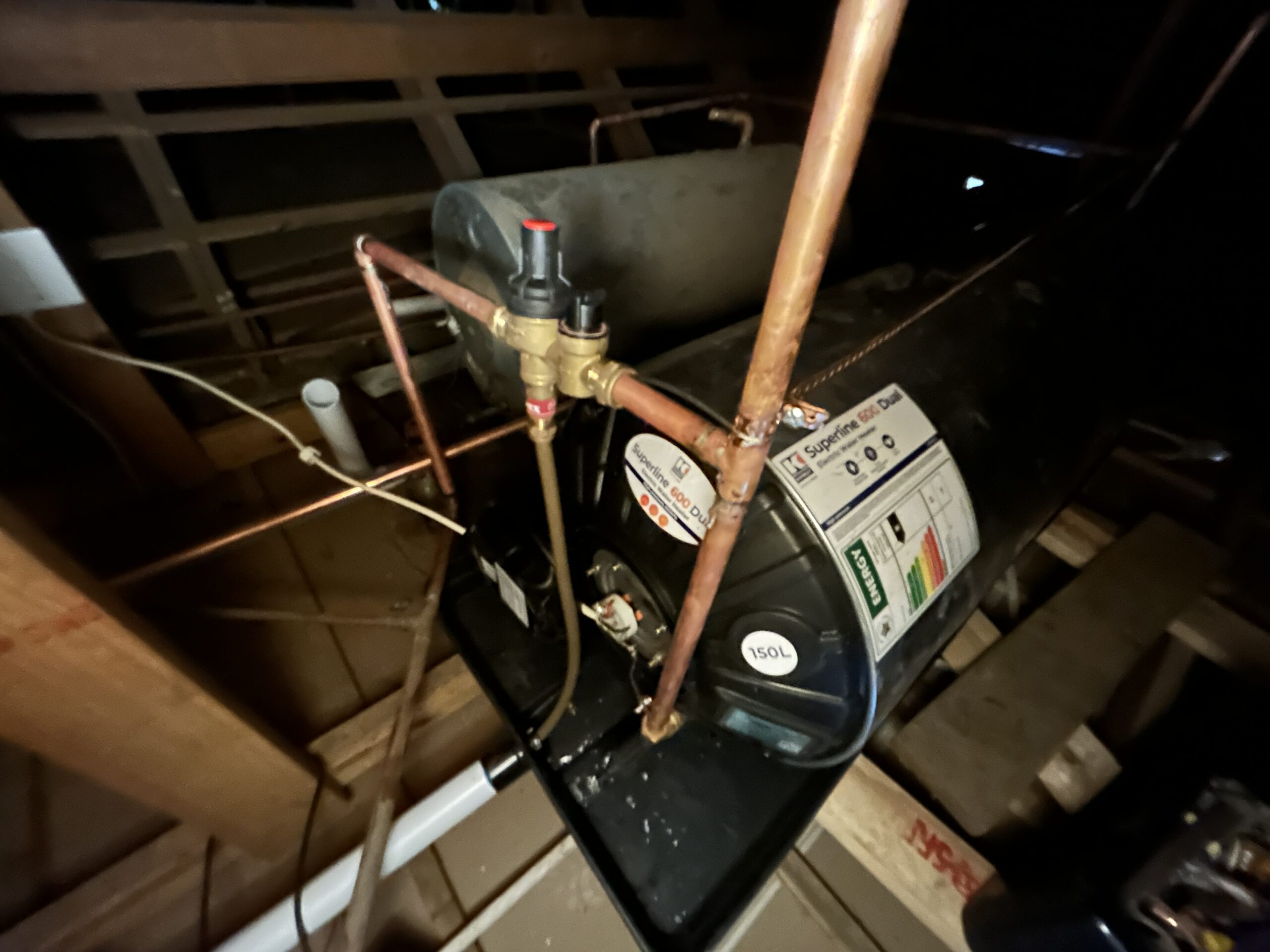 Horizontal 150L geyser installation in a Johannesburg attic, featuring professional copper piping, safety valves, and a drip tray, ensuring full PIRB compliance.