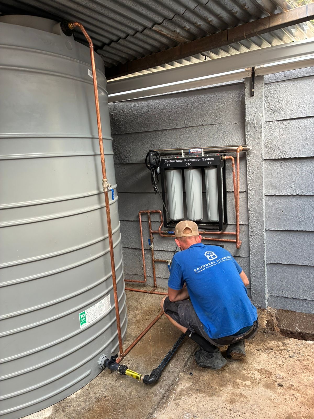 Saunders Plumbing technician installing copper piping for a JoJo water backup tank and central water purification system in Randburg.