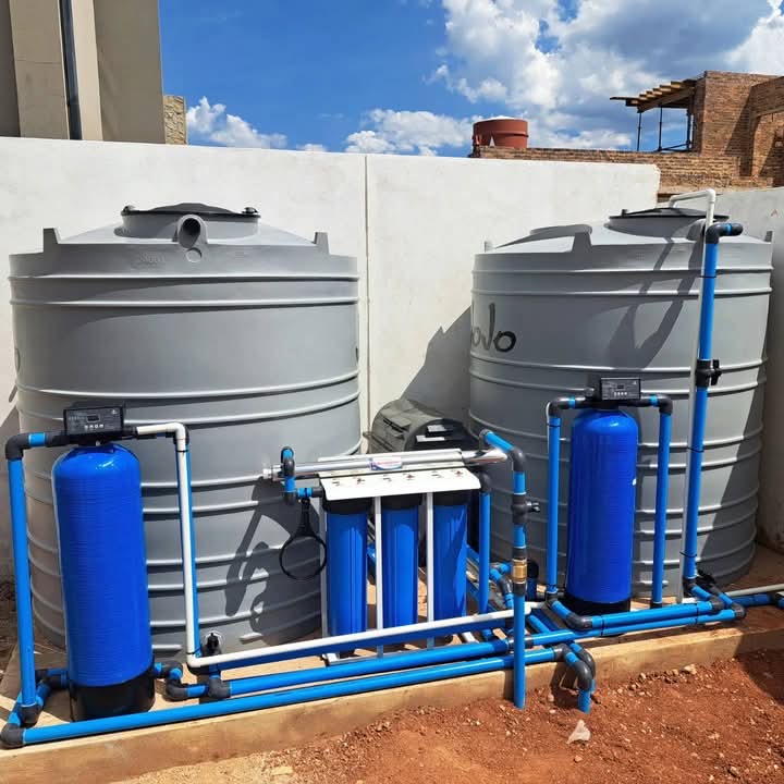 Outdoor installation of a JoJo water storage tank and blue water filtration system in Randburg by Saunders Plumbing.